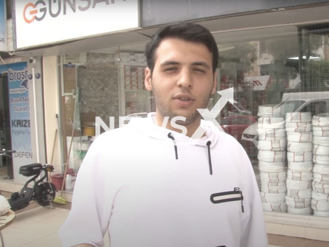 Photo shows a teen in Izmir, Turkey, undated. A cable shaped like a ring falls on a teen walking on the road and passes over his neck in Izmir, Turkey. Note: Picture is a screenshot from a video (Newsflash)