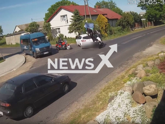 A driver and a passenger of the motorcycle fly off after they hit  a car in Krojczyn, Poland, on Wednesday, May 31, 2023.  Both were injured and taken to the hospital, and the driver, 28, of the car did not make sure that she could make a safe left turn, and  both drivers were intoxicated.  Note: Picture is a screenshot from a video (KPP w Lipnie/Newsflash)