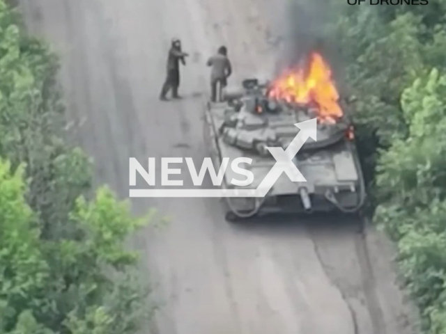 Picture shows Russian soldiers near burning Russian T-80 tank hit by Ukrainian drone in Kupiansk direction, in Kharkiv Oblast, Ukraine in undated footage. The footage was released by Yuriy Fedorenko, the commander of Achilles drone group of 92OMBr on Saturday, June 10, 2023. Note: Picture is a screenshot from a video (Achilles drone group of 92OMBr/Newsflash)