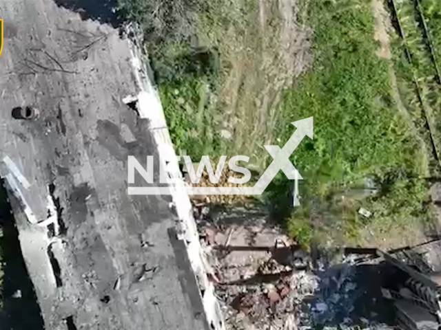 Ukrainian drone drops bomb on a bunch of Russian ammunition hidden near wall in Ukraine in undated footage. The footage was released by the 28th Mechanized Brigade on Monday, June 12, 2023. Note: Picture is a screenshot from a video (@28mechanizedbrigade/Newsflash)