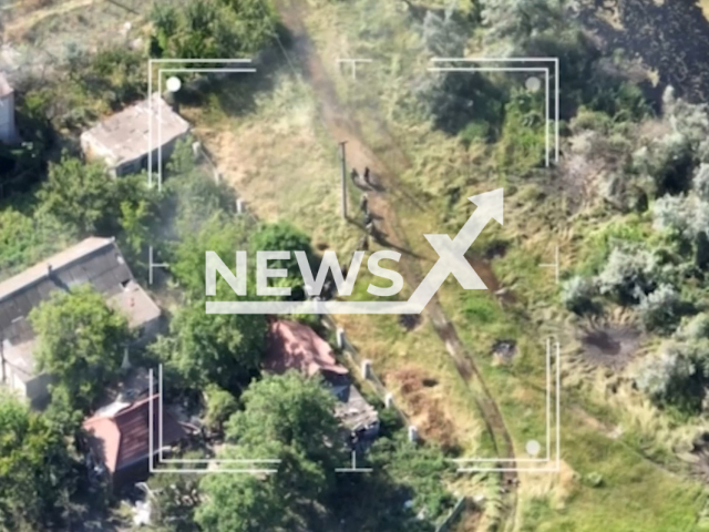 Russian soldiers move down the road in a residential area in the south of Ukraine in undated footage. The footage was released by the Special Operations Forces of the Armed Forces of Ukraine on Tuesday, June 13, 2023. Note: Picture is a screenshot from a video (@usofcom/Newsflash)