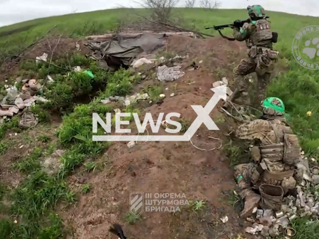 Soldiers of Ukrainian unit "Wolf Pack" of 3rd brigade clear the Russian positions in Ukraine in undated footage. The footage was released by the 3rd separate assault brigade on Tuesday, June 13, 2023. Note: This picture is a screenshot from the video. (@ab3army/Newsflash)