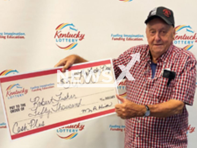 Robert Fisher poses with his lottery winning check, undated. Fisher said 'My birthday is a month away, so I’m going to call this an early birthday present,'. 
Note: Licensed photo.  (Kentucky Lottery/Newsflash)