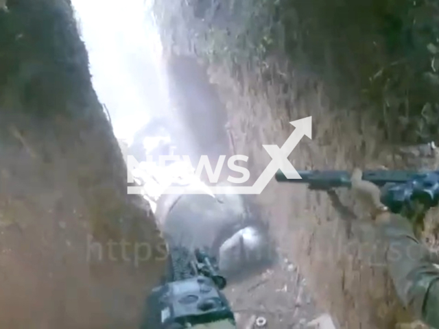 Ukrainian SSO fighter shoot at Russian soldiers in a trench in Southern Ukraine in undated footage. The footage was released by the Ukrainian Special Operations Forces on Monday, June 19, 2023. Note: Picture is a screenshot from a video (@ukr_sof/Newsflash)