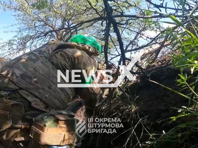 Ukrainian soldier shoots in a trench in Ukraine in undated footage. The footage was released by the 3rd separate assault brigade on Wednesday, June 21, 2023. Note: Picture is a screenshot from a video (@ab3army/Newsflash)