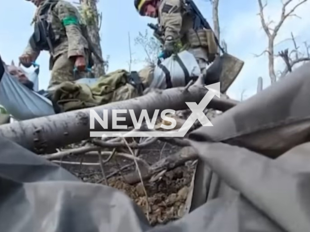 Ukrainian soldiers of the SSO rescue their wounded colleague under Russian fire in Ukraine in undated footage. The footage was released by the Command of the Ukrainian Special Operations Forces on Thursday, June 22, 2023. Note: Picture is a screenshot from a video (@usofcom/Newsflash)