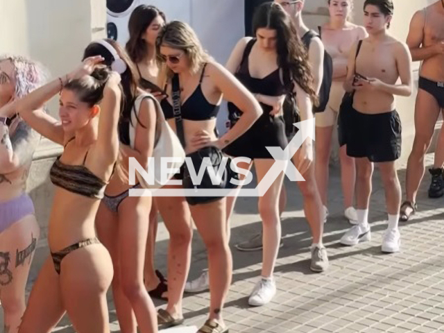 People in underwear line up in front of store in Madrid, Spain, on  Thursday June 22, 2023. The Desigual brand offered two items of clothing for free - without  a price limit, to people that went to the store in their underwear. Note: Photo is a screenshot from a video. (Newsflash)