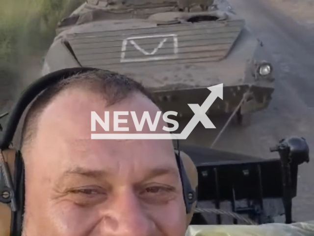 Happy Ukrainian soldier shows captured Russian BMP from battlefield in Ukraine in undated footage. The footage was released by the separate brigade of territorial defense of the city of Dnipro on Thursday, June 22, 2023. Note: Picture is a screenshot from a video (@BrTODnipro/Newsflash)