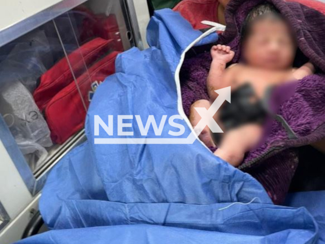 Picture shows the woman and the baby, undated. A migrant woman of Central American origin gave birth on a bus that was taking a group of 141 migrants to an auditorium   after being surprised inside a trailer on the Veracruz -Puebla highway, in Veracruz, Mexico. Note: INM photo. (@INAMI_mx/Newsflash)