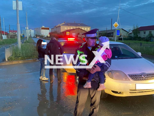 Police officer holds a kid in Yakutsk, Russia on Wednesday, June 21, 2023. Drunk man, 55, stole a car with two small children inside. Note: Photo is obtained from the Department of the State Inspectorate for Road Safety of the Department of the Ministry of Internal Affairs of Russia in Yakutia. (@gibdd14/Newsflash)