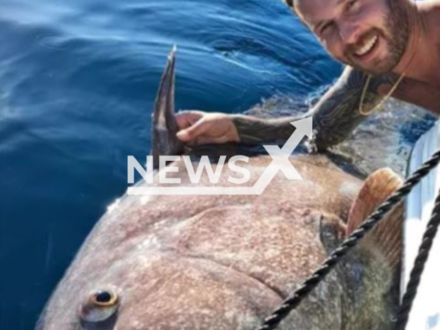 Marcelo Lopes Rodrigues, 33,  poses with a 180 kilogrames fish, on Sunday, June 25, 2023. It took 50 minutes to remove the grouper from the water.  Note: Private photo.  (Marcelo Lopes Rodrigues/Newsflash)