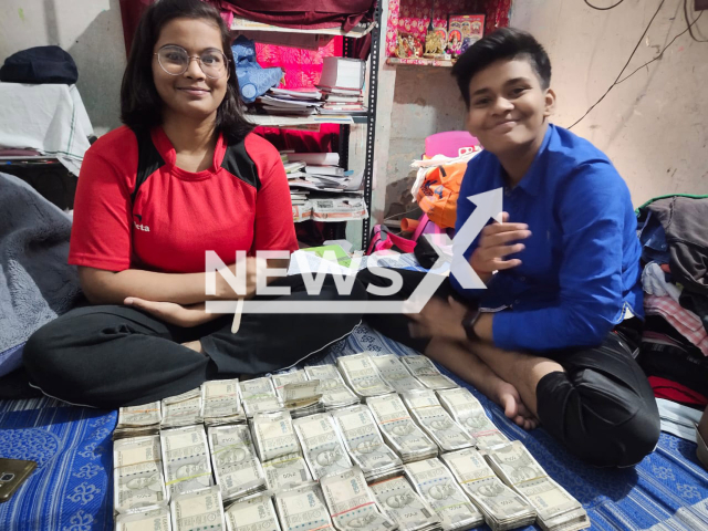 Photo shows two children with bundles of money, undated. Uttar Pradesh Police Sub-Inspector Ramesh Sahni, currently stationed in the Beta Mujawar area of Unnao district in India, has found himself embroiled in controversy as pictures showcasing his children posing with stacks of money have gone viral on various social media platforms. Note: Picture is private (Newsflash)