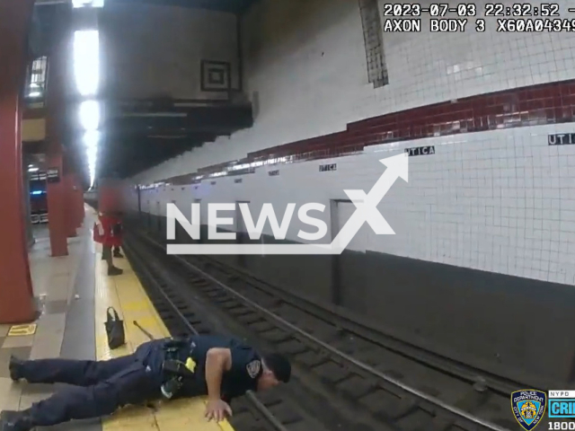 Police officers rescue a man who fell on subway tracks in Brooklyn, New York, Monday, July 3, 2023. The man suffered a medical episode. Note: Picture is a screenshot from a video (NYPD/Newsflash)