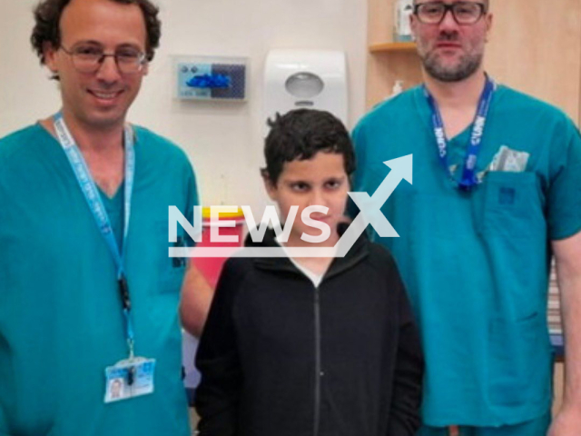 Photo shows Suleiman Hassan, a 12-year-old Arab boy from the West Bank, with doctors, undated. His head was internally severed from his neck after he was hit by a car while cycling in June 2023. Note: Picture is private (@hadassah_medical_center/Newsflash)