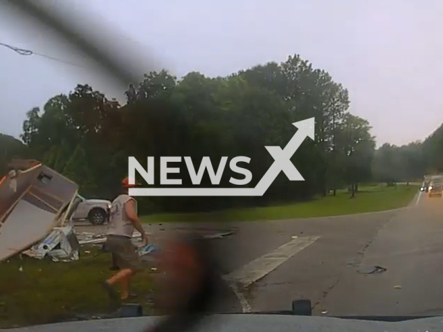 Troup County Deputy Carrla Querry safely removes the truck occupants with the help of the citizens before the vehicle was totally engulfed in flames in Troup County, Georgia, Friday, June 30, 2023. Troup County Fire Department arrived and quickly extinguished the fire and the victims were treated for their injuries. Note: Picture is a screenshot from a video (@troupsheriff/Newsflash)