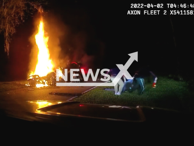 Officers rescue a man from a burning vehicle on April 2nd, 2022 in Charlotte County, Florida, USA. Note: This picture is a screenshot from the video (Charlotte County Sheriff's Office Florida/Newsflash).