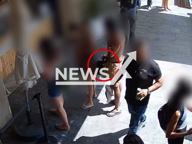 A Police officer catches a man while secretly filming a 12-year-old girl at Gordon Beach in Tel Aviv, Israel, undated. The suspect appeared before the Tel Aviv Magistrate's Court, which decided to release him to house arrest. Note: This picture is a screenshot from the video. (@israelpolice/Newsflash)