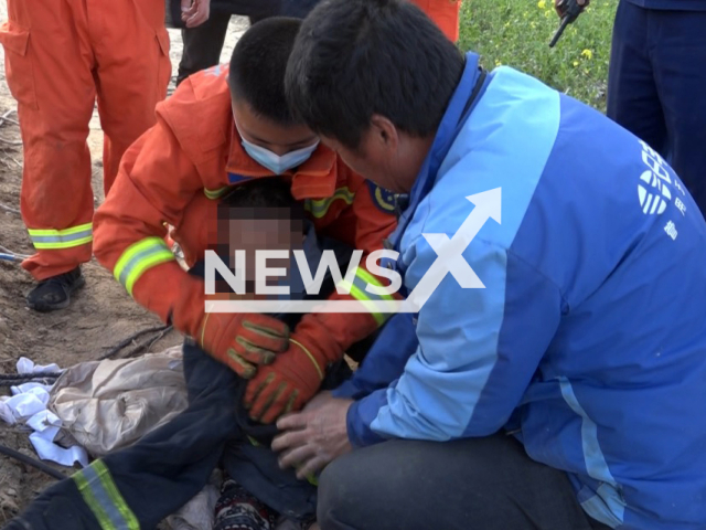 The six-year-old boy who fell in the well was rescued in Zhangguzhai Village, Guangzong County in China. Note: Firemen photo. (Hebei Fire/AsiaWire)