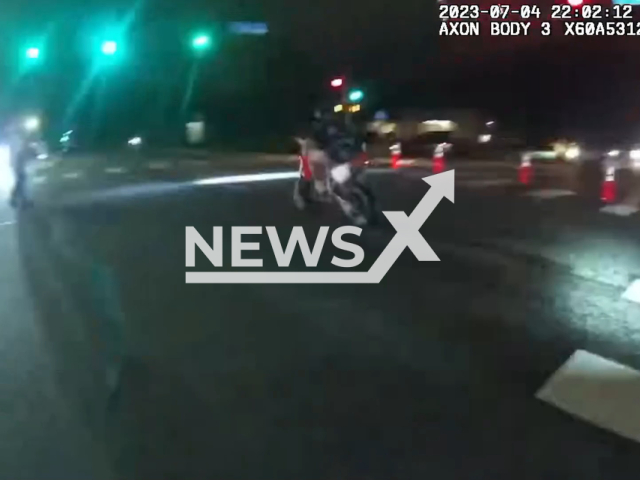 Police remove a rider, identified as Trey Patrick Bailey from a motorcycle after he was allegedly riding high-speed down closed streets following the July 4th celebration in Arvada, USA, Tuesday, July 4, 2023. Two police officers received minor injuries and Bailey was taken to jail. Note: Picture is a screenshot from a video (Arvada Police Department Colorado/Newsflash)