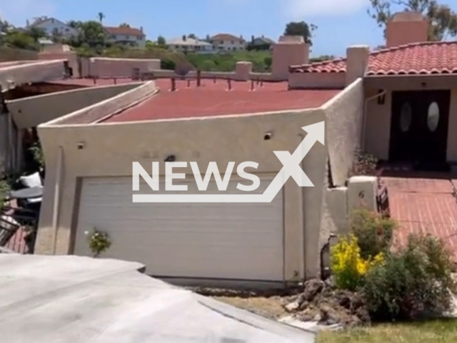 Image shows home threatened by a sliding hillside, undated photo. About a dozen families have been evacuated in the city of Rolling Hills Estates, Los Angeles County, California State, USA, in July 2023. Note: Photo is a screenshot from a video. (L.A. County Fire Department/Newsflash)