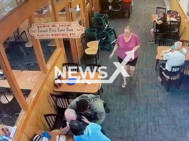 Photo shows Gwinnett County Police Department officer rescuing a man who was choking. The man was saved at a Golden Corral restaurant on Satellite Boulevard on Friday, June 30, 2023.
Note: Photo is a screenshot from a video(@GwinnettPD/Newsflash).