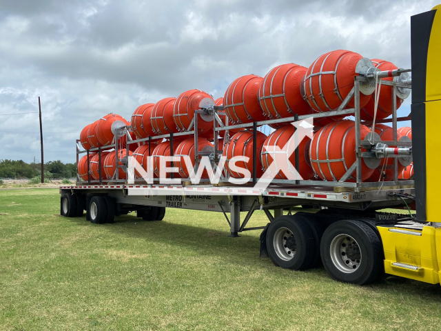 Photo shows the buoys for the marine barrier on the Rio Grande beg. The installation began. 
Note: Licensed photo(@TxDPS/Newsflash).