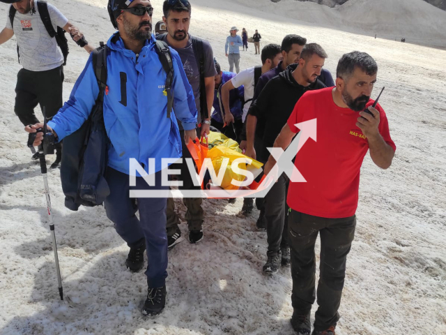 Rescuers carry a person to a helicopter after being rescued inside a glacier in Cilo Mountain in Hakkari, Turkey, undated. Four people fell into a crevasse in Cilo Mountain in Hakkari, Turkey, Sunday, July 16, 2023. Note: Photo was provided to us by Ferhat Basdinc (@gezginn_adammm/Newsflash)