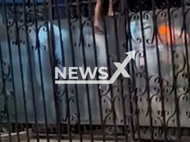 A naked man climbing a fence at the Almaty airport, in Kazakhstan, on 6th April, 2022. Note: This picture is a screenshot from the video (Newsflash).