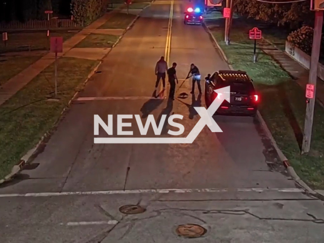 Image shows cops rescue a racoon with a mayo jar stuck on its head, undated photo. It happened in a neighbourhood in Florida State, USA, on its head on Thursday, July 13, 2023. Note: Photo is a screenshot from a video. (Painesville Police Department/Newsflash)