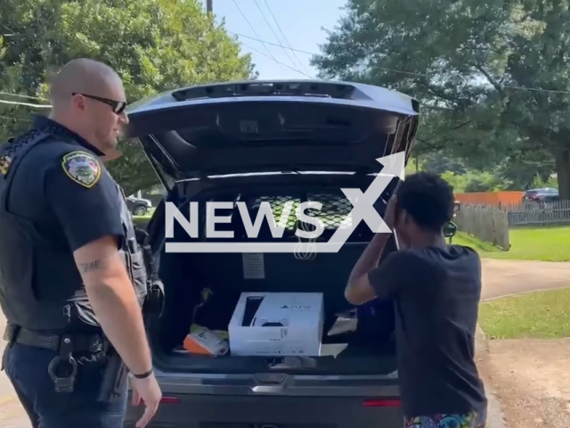 Police officer surprises boy with PlayStation in Hapeville, Georgia, undated. Officer Colleran made contact with the child who explained he was in the area because he wanted to do yard work. Note: Picture is a screenshot from a video (Hapeville Police/Newsflash)