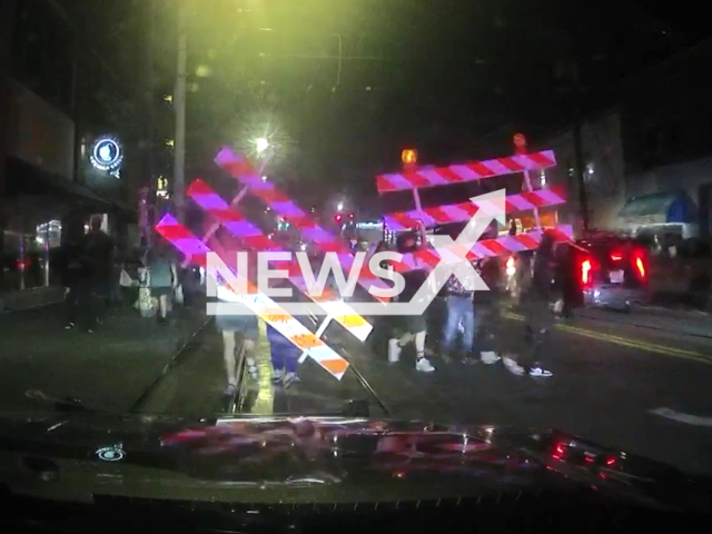 Video Shows Seattle Cop Car Attacked During Illegal Street Racing event in Seattle, United States on 23 July 2023. Note: This picture is a screenshot from the video. (Seattle Police Department/Clipzilla)