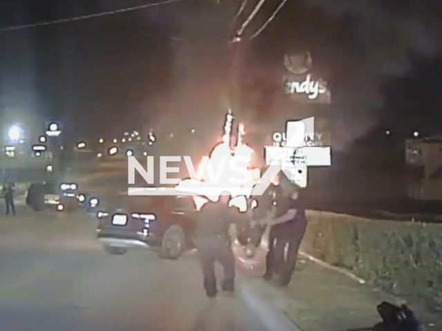 White Settlement officers rescue unconscious man from burning car after crash in White Settlement city in, Texas, United States on 29 July 2023. Note: This picture is a screenshot from the video. (White Settlement Police Department/Clipzilla)