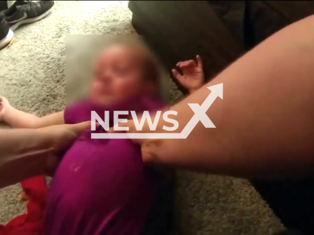 Bodycam footage shows officers performing CPR on the little girl, who was found drowning in a swimming pool in the backyard of the home in El Mirage, Arizona, United States on 22 July 2023. Note: This picture is a screenshot from the video. (El Mirage Police Department/Clizilla)