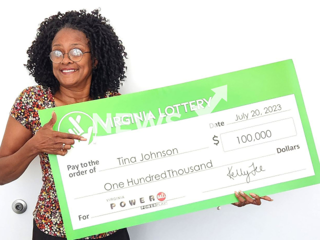 Tina Renee Johnson poses with her Powerball check, undated. Her cousin convinced her to buy the ticket and won USD 100 thousand (GBP 78 764).
Note: Licenced photo. (Virginia Lottery/Newsflash)