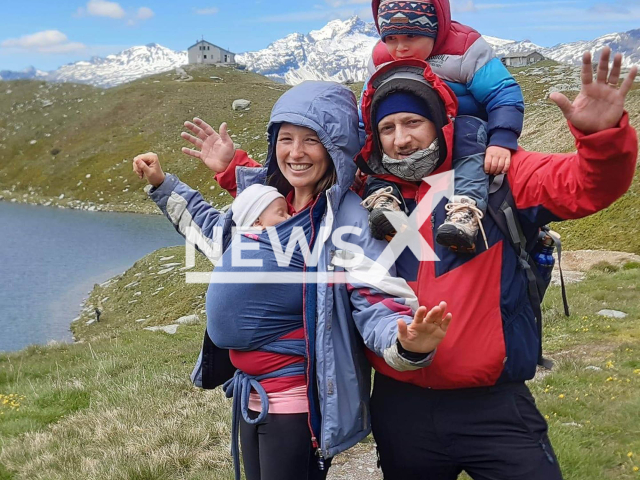 Giulia Pozzebon, 35, poses with unidentified man and children in undated photo. She was hiking with a friend when they were surprised at a high altitude by bad weather and she  slipped, falling over 150 meters, and died on Monte Limidario, Italy, Friday, Aug. 4, 2023. Note: Private photo.  (Newsflash)