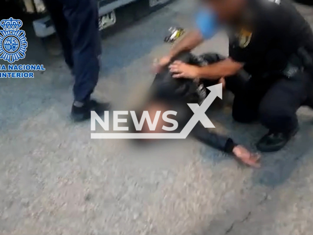 Moment cops are trying to help a migrant who was found locked in a container. It happened in the port of Algeciras, in Cadiz province, southern Spanish region of Andalusia. Note: Photo is a screenshot of a video. (Newsflash)