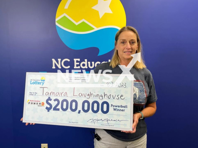 Tamara Laughinghouse poses with her Powerball win check, undated. She used  special birthday numbers to win. Note: Licensed photo. (Multi-State Lottery Association/Newsflash)