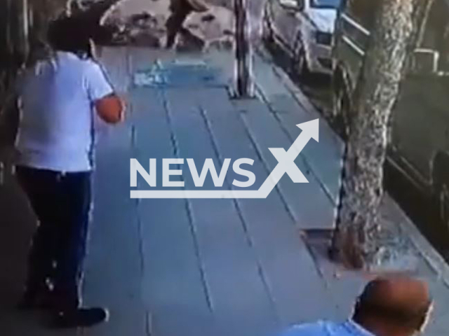 Concrete blocks fall from a building on a man and his daughter walking on the pavement in Aksehir, Konya, Wednesday, Aug. 2, 2023. The father and his daughter were injured.Note: Picture is screenshot from a video. (Newsflash)