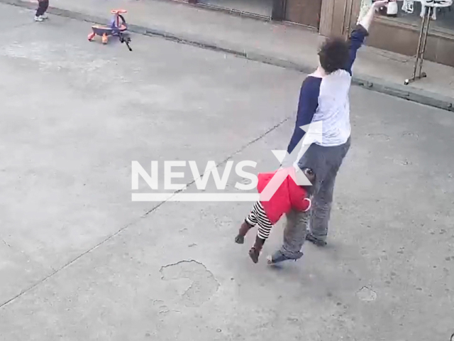 Little girl dangles as dad holds her and plays badminton in Jiaxing, Zhejiang in China. Note: This picture is a screenshot from the video (BYDT111/AsiaWire).