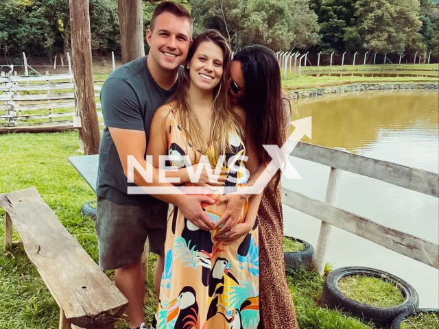 A Brazillian woman, Maria Carolina Rizola, 30, (middle), who is in a relationship both with her husband Douglas Queiroz, 33, (left) and Klayse Marques, 34, (right) is pregnant with a baby boy. Note: We have obtained permission for this photo (@meutrisal/Newsflash)