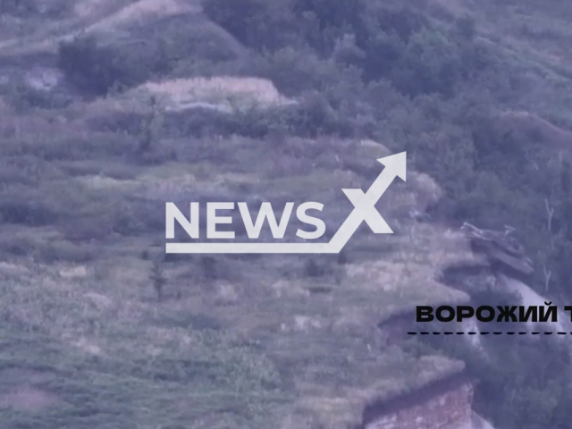 Russian tank falls into a ditch and gets stuck before the Ukrainian drone hits it and triggers a massive explosion in Ukraine in undated footage. The footage was released by the 80th separate amphibious assault brigade on Thursday, Aug. 10, 2023.
Notes: Photo is screen from a video. (@80brigade/Newsflash)