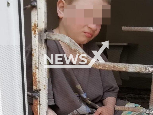 Photo shows a boy behind iron bars in a house in Georgiyevsk, Russia, undated. His mother was reportedly sentenced to 3.5 years for torturing her two children. Note: Picture is private (Newsflash)