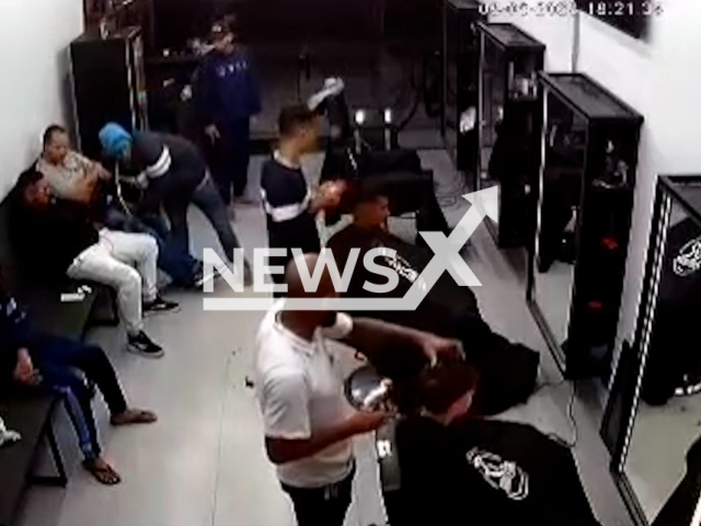 Barbers carry on cutting hair during a robbery in a barber shop in Guaianases, Sao Paulo, Brazil, Tuesday, Aug. 8, 2023. Seven people were in the barber shop when they were robbed by the criminals.Note: Picture is screenshot from a video. (Newsflash)