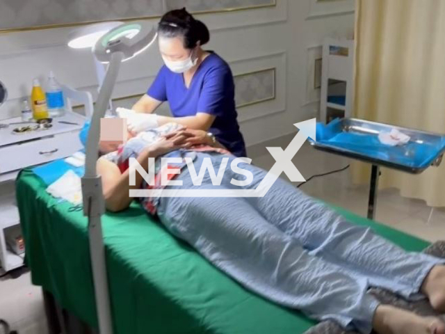 The janitor performs a facelift for a  customer at the beauty salon, in Da Nang, Vietnam,  on Saturday,  Aug. 12, 2023. Police  checked the observance of the law on environmental protection at  the  beauty salon and discovered that this had many violations. Note: Police photo. (Thanh Khe District Police/Newsflash)