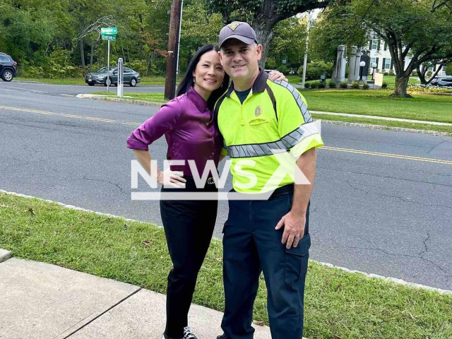 Lucy Liu was poses with a police  officer  in Cranford, News Jersey, USA, on Tuesday, Sept. 19, 2023. She  was filming in the township. Note: Police photo. (Cranford Police Department/Newsflash)