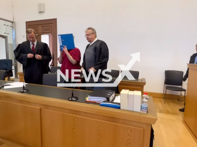 Photo shows Jan-Heiko Pflur hiding his face at the Giessen regional court on Monday, September 25, 2023. He faces life behind bars for the murder of Ayleen Ambs, 14, whose body was found in a lake in Gottenheim, Germany, on Friday, July 29, 2022. Note: Photo is a screenshot from a video(Newsflash).