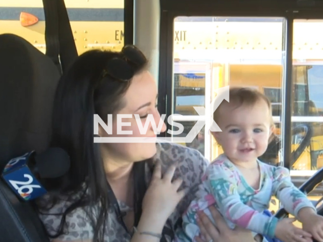 Sydney Reichert and her daughter Nova  pose in the school bus, undated. Sydney is a bus driver in   Kaukauna, Wisconsin, USA, and takes her daughter to work with her.  Note: Photo is a screenshot from video. (Newsflash)