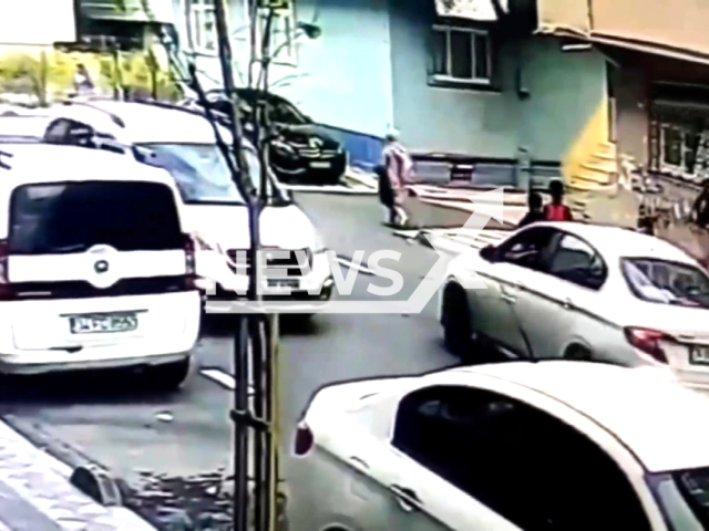 A schoolboy applies the handbrake on a moving car while its driver checks another child in Sultangazi, Istanbul, undated. The schoolboy prevented an accident by acting proactively.Note: Picture is screenshot from a video. (Newsflash)