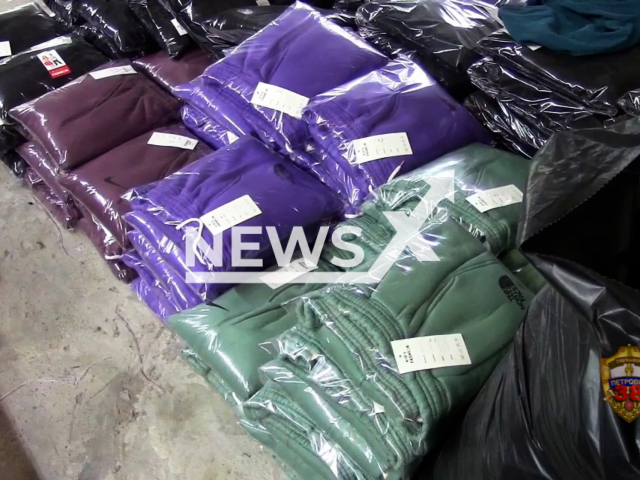 Footage shows clothes with logos of Nike и The North Face made by illegal workers in a large illegal workshop for sewing on Varshavskoye Highway in Moscow, Russia, undated. Clothes and sewing machines were seized. Note: Picture is screenshot from a video. (Russian Ministry of Internal Affairs/Newsflash)