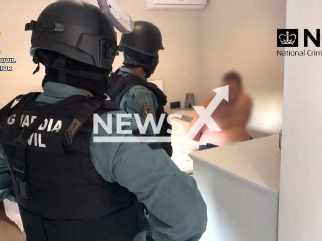 Spanish authorities detain a British man, wanted over alleged drug offences, in the resort of Javea north of Alicante, undated. His home was searched in an operation involving the UK's National Crime Agency and Metropolitan Police, as well as officers from the Civil Guard's elite UCO Central Operative Unit. Note: Picture is screenshot from a video. (Civil Guard/Newsflash)